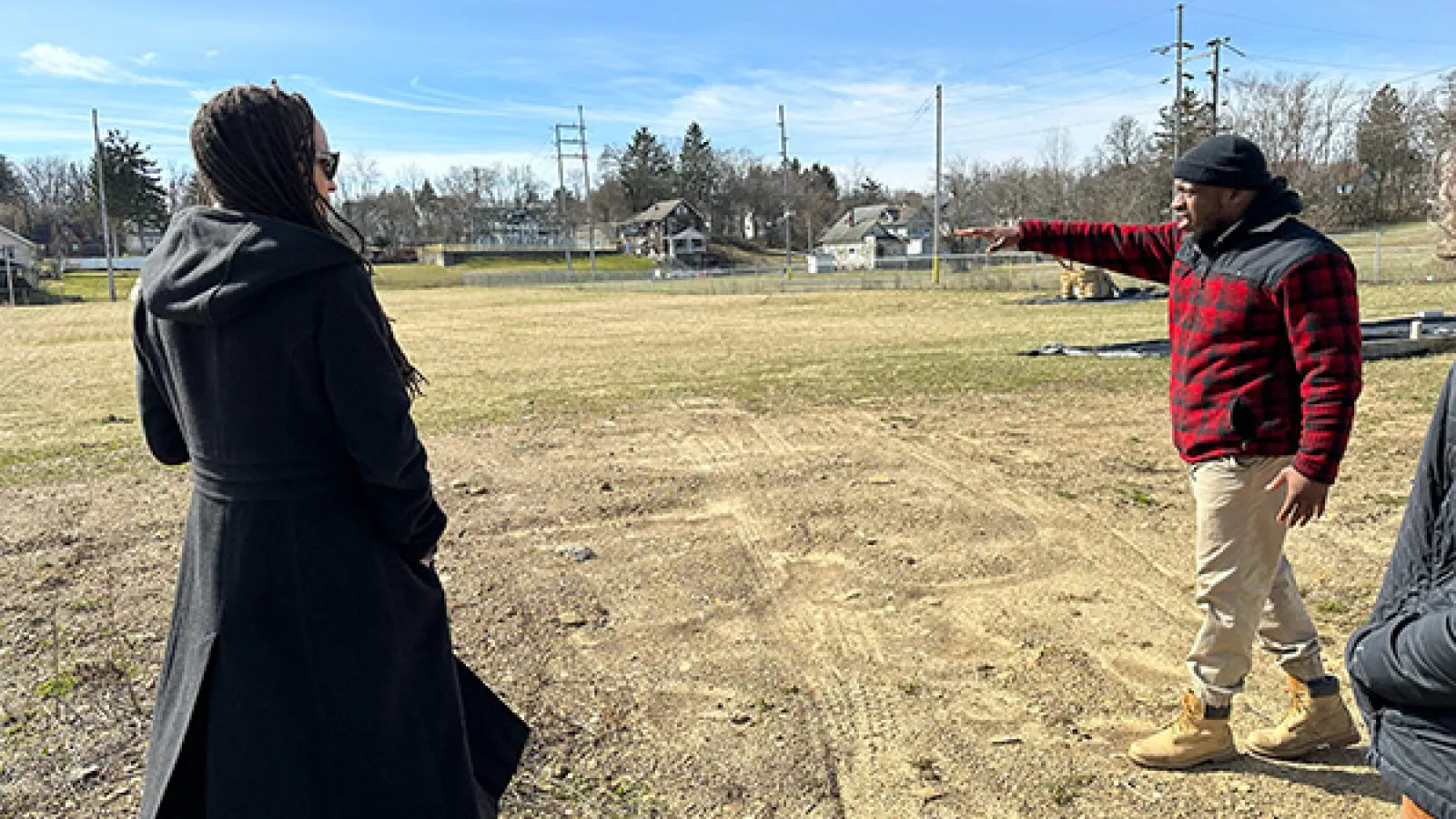 Mansfield Urban Farm Manager Walt Bonham points to an unused area of the Urban Farm while explaining plans for future to Dr. Tiyi Morris.