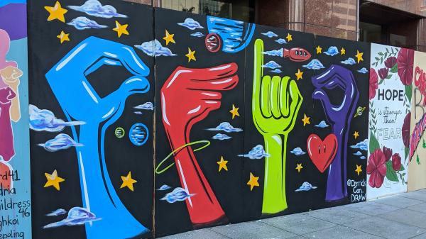 A colorful mural from Columbus, Ohio, spelling Ohio in sign language