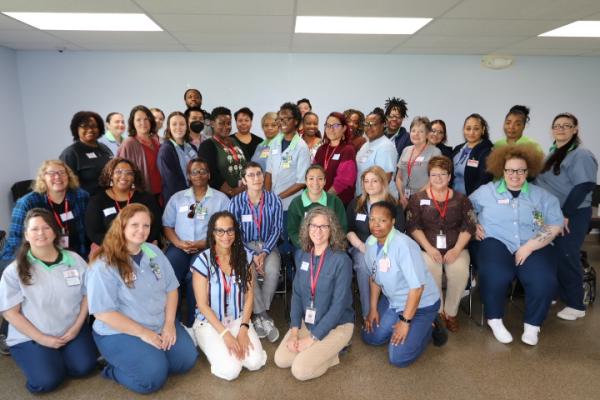 Large group of OSU faculty and incarcerated students pose for a photo during OPEEP's May 2024 instructor training at the Ohio Reformatory for Women.