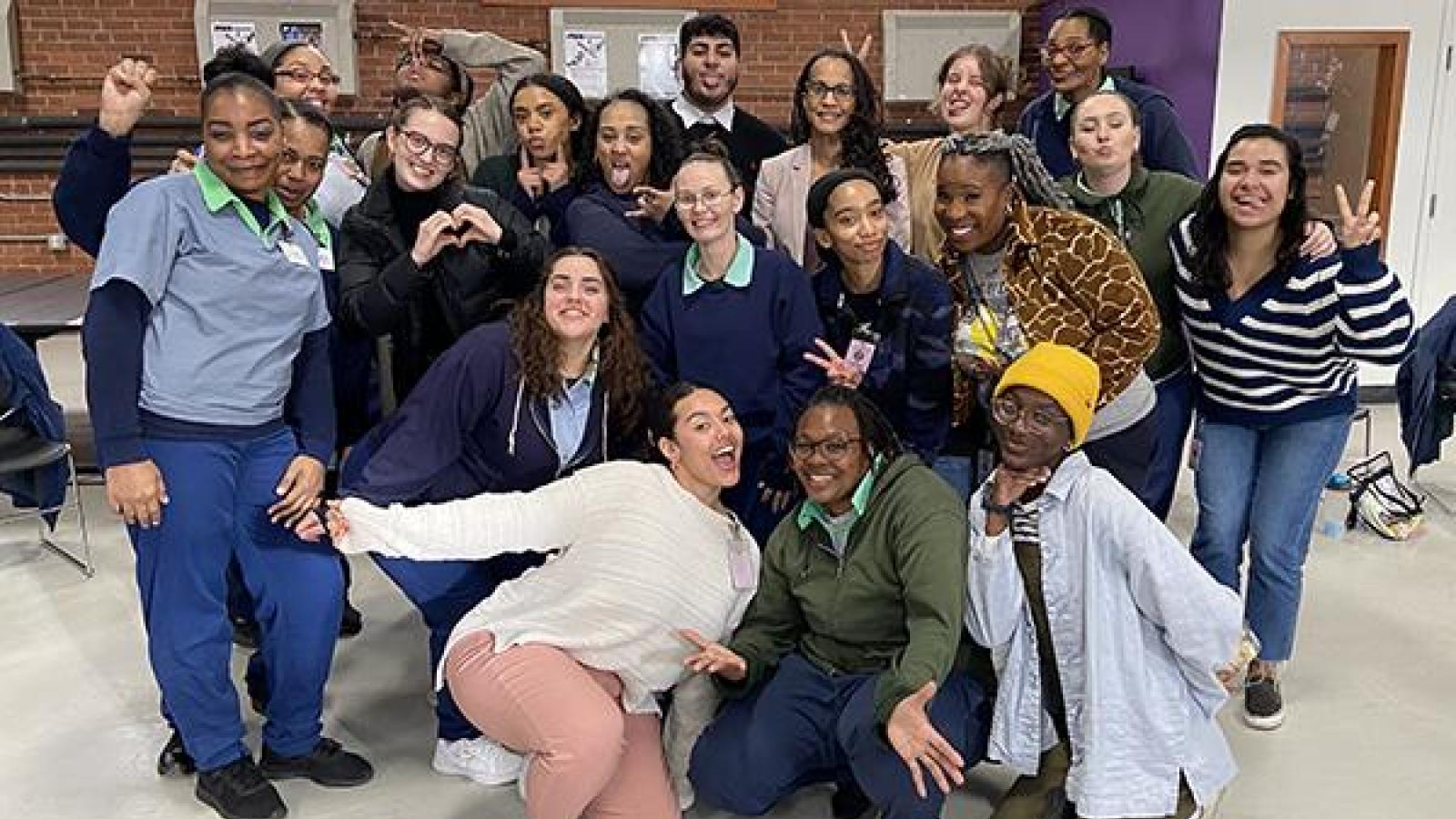 A group of Professor Tiyi Morris' students smile and pose from her Spring 2022 Course AAAS 3083: "The Civil Rights and Black Power Movements," at the Ohio Reformatory for Women.