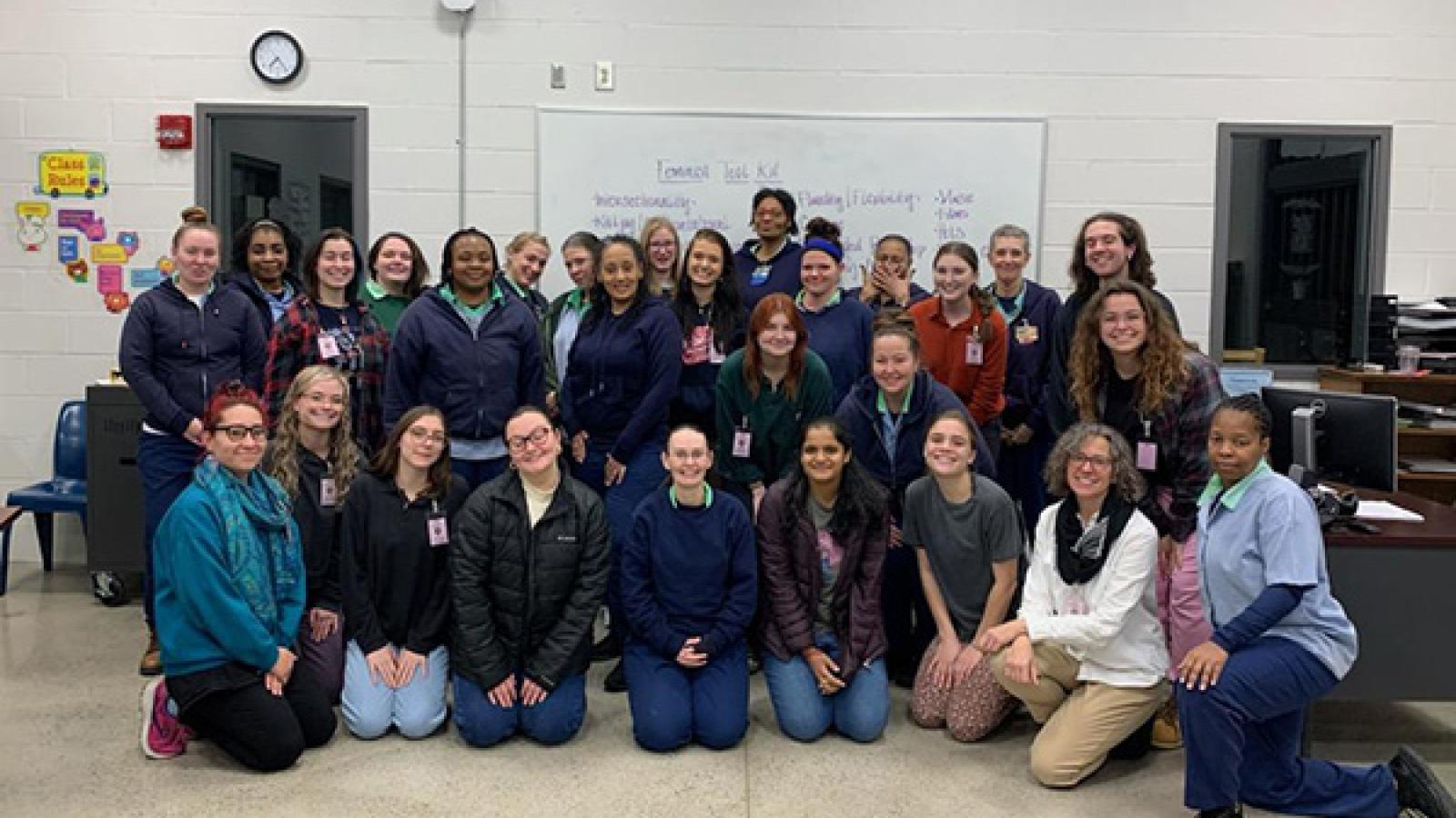 Students from Dr. Mary Thomas' Autumn 2022 WGSS 1110H class smile for a group photo taken during their final day of class at the Ohio Reformatory for Women.