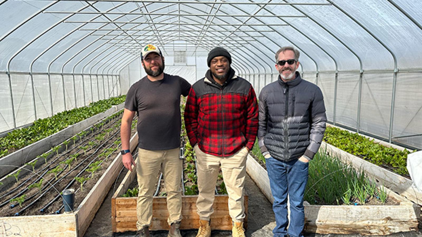 Daniel Neef, Walt Bonham, and Kip Curtis pose for a photo at the NECIC Urban Farm in Mansfield, OH